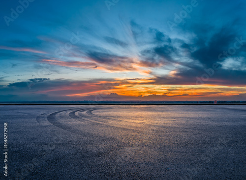 Empty asphalt road square and tire track with beautiful sky clouds at dusk