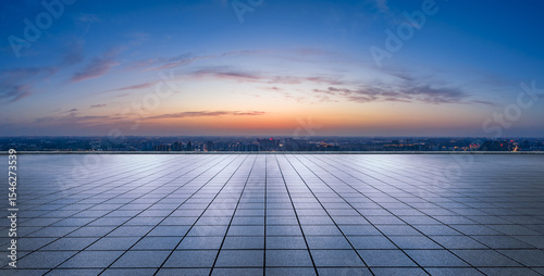 Empty square floor and city skyline with beautiful sky clouds at night