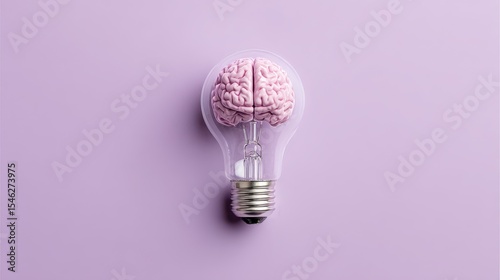 Ultra quality image of light bulb with human brain model inside on isolated pastel purple background. Top view, minimal flat lay. Concept of creative ideas, innovation, invention.