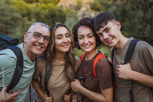 happy family of backpackers hikers explore nature together