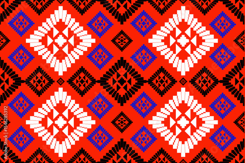 A vibrant tribal-inspired pixel art pattern featuring bold geometric diamond motifs in red, blue, white, and black. Designed with a Southwestern and folk aesthetic, this seamless textile design is per
