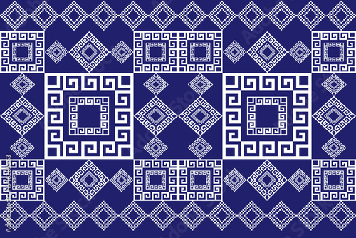 A clean and bold pixel-style pattern featuring geometric diamond shapes and Greek-inspired motifs in white over a rich blue background. This seamless tribal textile design blends modern minimalism wit