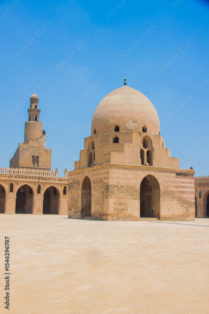 Fototapeta premium Tolon old Cairo, Ahmed Ibn Tolon Mosque, minaret and dome, islamic civilization and archeology, blue sky, shot is selective focus with shallow depth of field, taken at Cairo Egypt