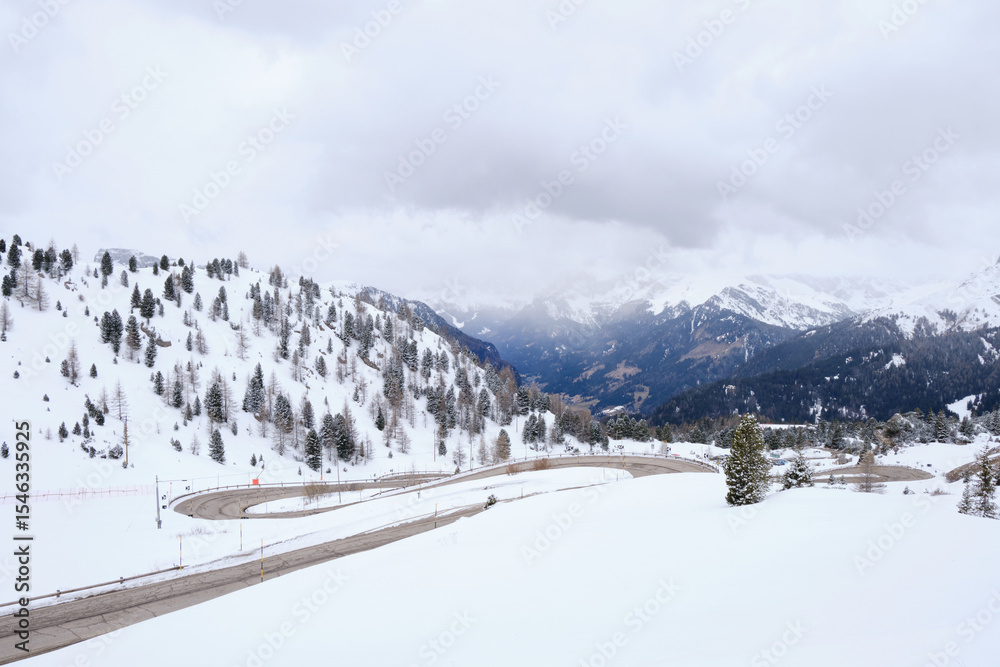 March 2025: view of Pordoi Pass and snowy road, Dolomites, Italy March 2025: view of Pordoi Pass and snowy road, Dolomites, Italy