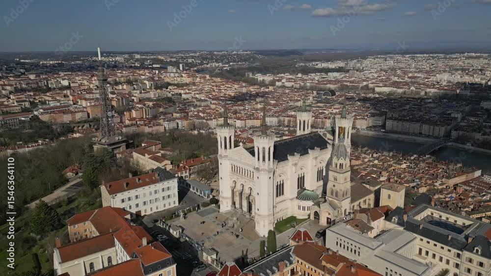 Notre-Dame de Fourvière Basilica in Lyon, France, viewed from below on a clear day – historic religious architecture and iconic city landmark under blue sky Notre-Dame de Fourvière Basilica in Lyon, France, viewed from below on a clear day – historic religious architecture and iconic city landmark under blue sky
