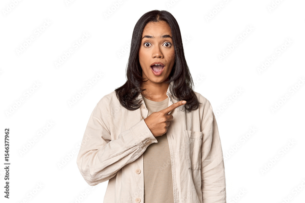Portrait of a young Filipino woman pointing to the side Portrait of a young Filipino woman pointing to the side