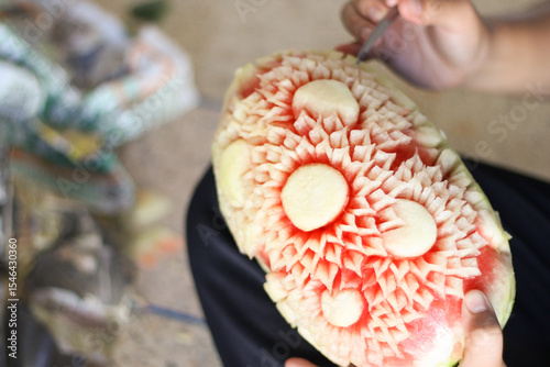 beautifully carved watermelon showcases the intricate art of Thai fruit carving.