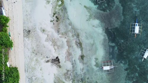 Aerial top view of beautiful tropical beach with white sand and boats in sea, Philippines, 4k