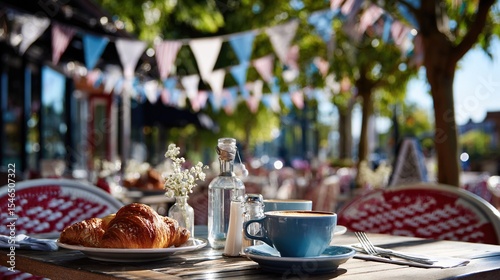 Charming outdoor French café table with croissant, coffee, and bunting flags under tree shade for festive morning celebration or tourism visuals