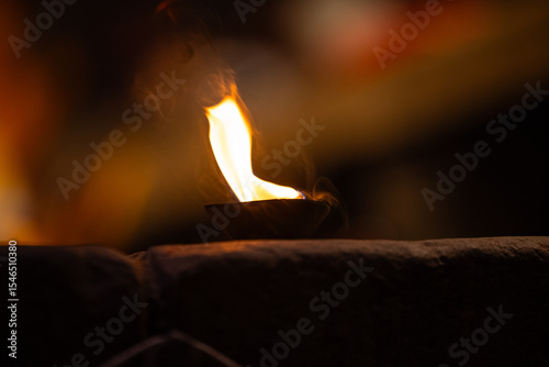 Ganga aarti, Fire flame at night with dark background during the ganga aarti rituals at river bank of Varanasi.