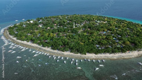 Aerial view of tropical island Balicasag surrounded by turquoise waters and coral reefs, Philippines, 4k