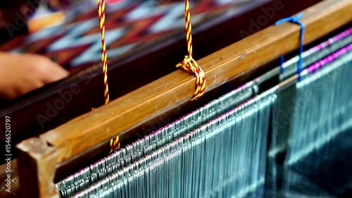 Making tenun ikat Bandar, Indonesia. An Indonesian woman weaving traditional fabric. Traditional weaving cotton in Indonesia.