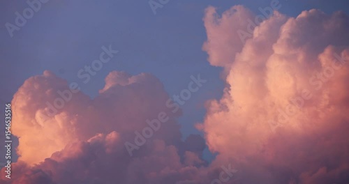 Beautiful volumetric clouds in the evening before sunset in motion