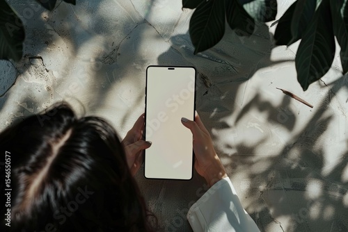 Top View, a Female Using Her Smartphone to Watch an Online Video Phone White Screen Mockup photo