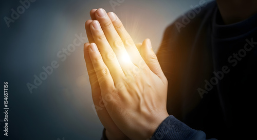 Person Praying with Hands Clasped, Prayer, Spirituality, Hope, Belief, Faith, Religion, Gesture, Close-up, Divine Light, Spiritual, Peace, Guidance.