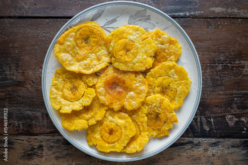 Delicious patacones or tostones on ceramic plate