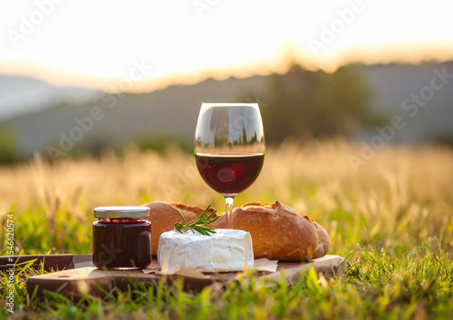 verre de vin rouge et plateau de fromages , à déguster à la campagne