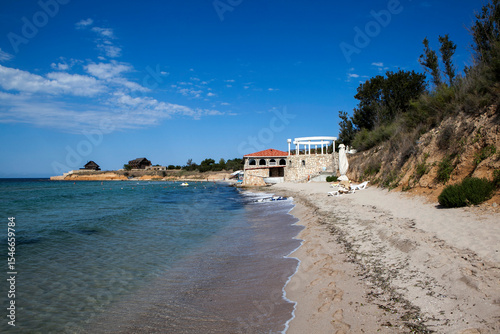 Snow-white sand and blue water of the picturesque beach 