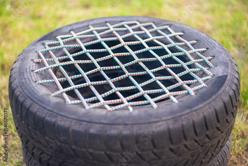 Garden chair made from an old car tire bound with rope. Reusing tires