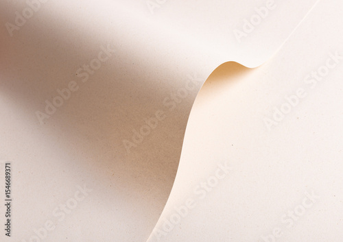 Elegant designer paper in creamy beige tones with folded and wavy shape. Natural recycled material