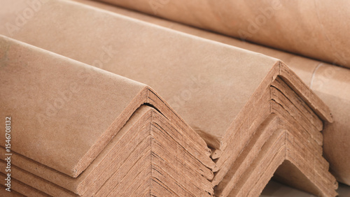 Cuadro en lienzo Stack of cardboard corner protectors for packaging, corners are brown and arranged in a row as background templates of pages and banners of delivery logistics concept