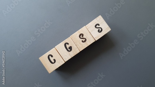 CGSS acronym made of wooden letter cubes on dark background. Caisse Générale de Sécurité Sociale (General Social Security Fund, overseas territories)