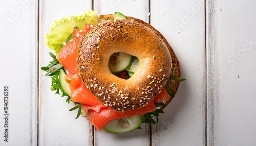 lox bagel a sandwich with smoked salmon and fresh vegetables on a white background overhead flat lay shot with sesame seeds