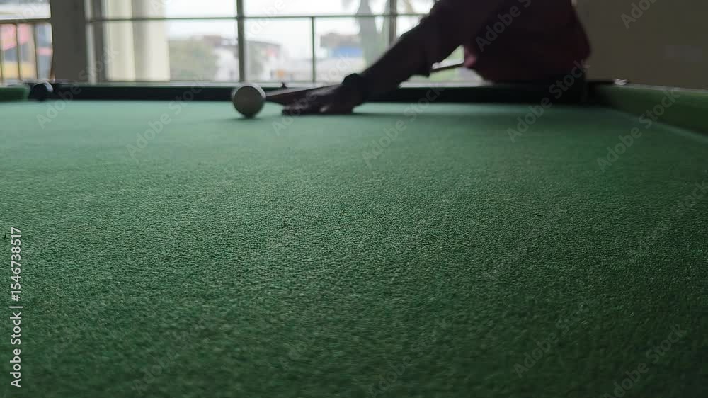 Unrecognizable professional adult player playing pool, snooker or billiards indoor sport game. Closeup of green table with copyspace. Recreation, hobby, entertainment or leisure activity concept.