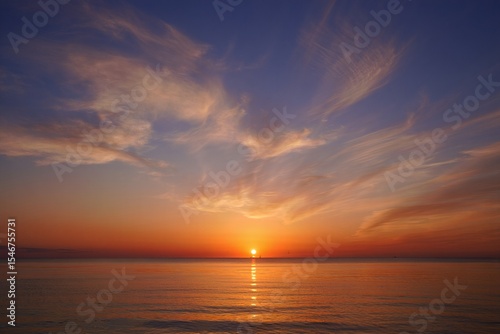 Vibrant sunrise over calm ocean orange sky free beach background Sunset