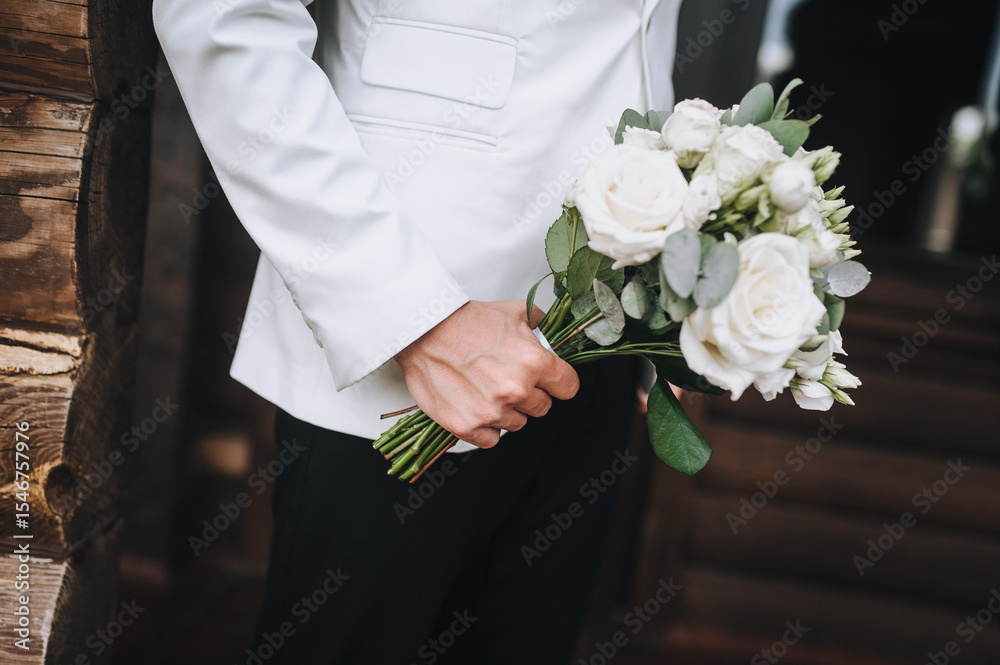 Young man in a suit holding a beautiful bouquet of flowers. Wedding photography, portrait. Young man in a suit holding a beautiful bouquet of flowers. Wedding photography, portrait.