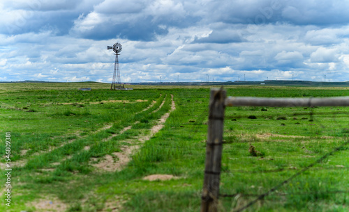 Small old wind turbine in a field against a cloudy sky in Tennessee, USA