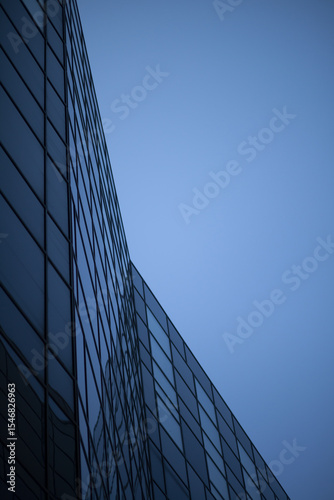 Modern glass office building with blue reflections - Corporate architecture background
