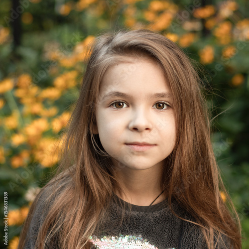 Portrait of a young girl with natural background and thoughtful expression