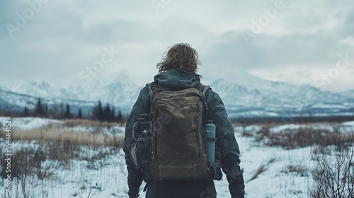 Hiker trekking snowy mountain landscape, winter