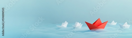 Origami boats, one red, in a light blue sea