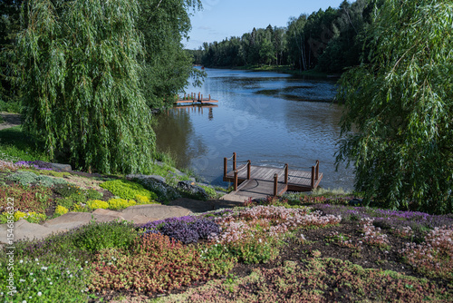 A Serene Lakeside Landscape Showcasing Vibrant Flora, Peaceful Calm Waters and Scenic Views