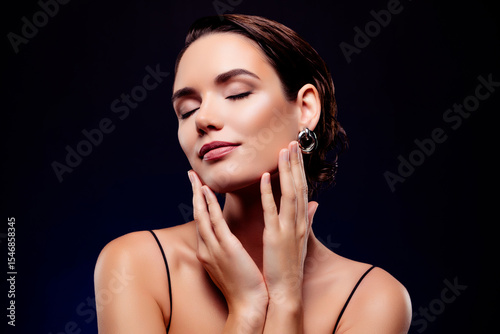Photo of charming lovely woman star enjoying make up visage isolated on dark blue background