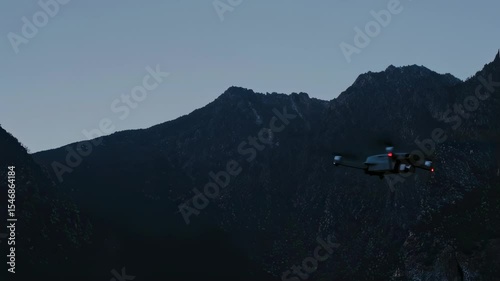 Aerial drone flight over majestic high mountain peaks during clear daylight.  
