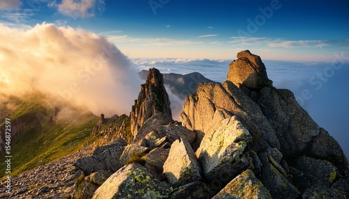 rocks on the top of mountain with clouds in the background