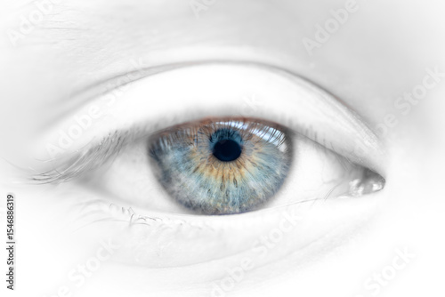 Blue Green Brown female Eye on desaturated facial skin. Highly detailed anatomical structure of the human iris. Taken in daylight.