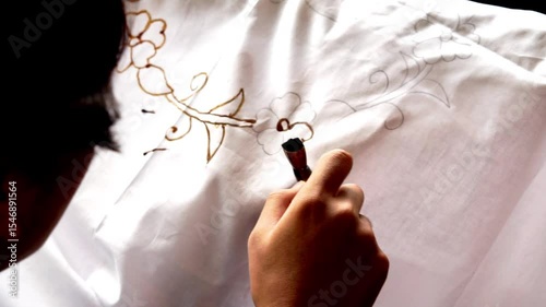 The process of making batik cloth. Batik is a type of cloth whose motifs are made manually, originating from Indonesia.