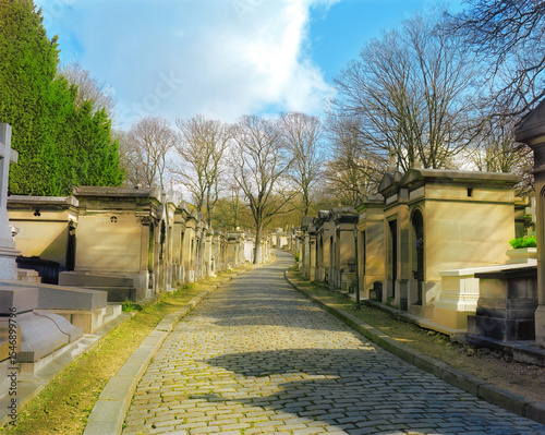 Aged mausoleums along a cobblestone cemetery path