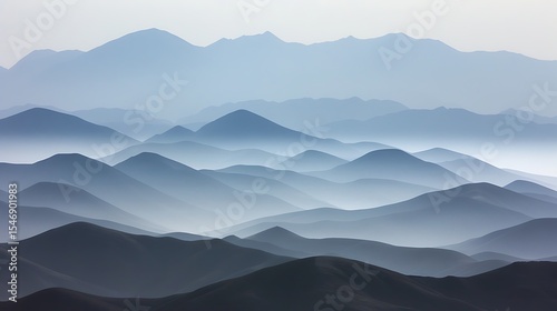 A misty mountain landscape with layers of hills fading into the distance