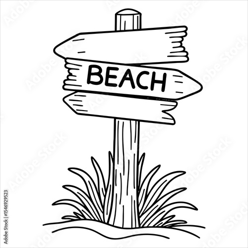 A signpost pointing towards the beach stands in sand surrounded by grass