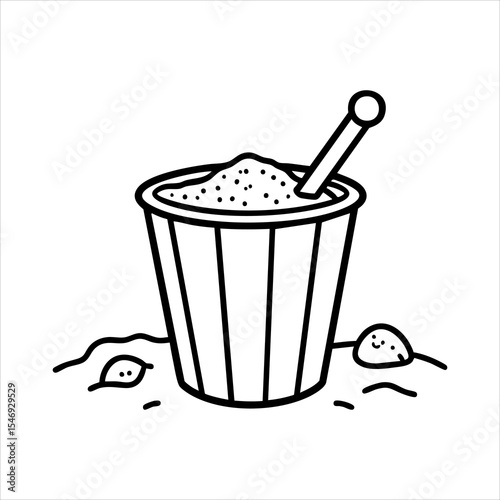 A sand bucket with a shovel situated on a surface covered in sand