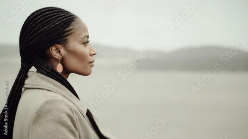 beach orienteering scene featuring person in right corner gazing into distance with dreamy expression