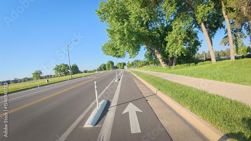 Fényképezés Bike lane separated from a car traffic on a street in Fort Collins, Colorado - b