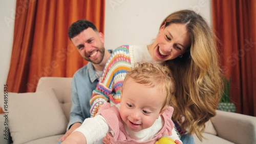 Happy family enjoying precious moments while engaging with their delightful baby and colorful toys in a cozy setting filled with warmth and love, creating cherished memories together.