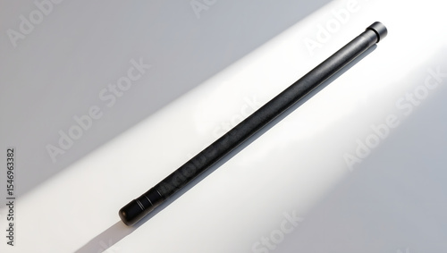 Wallpaper Mural A modern black pen lays against a surface, illuminated by soft light, displaying simplicity and elegance. Torontodigital.ca