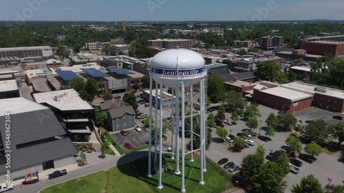 flying over iconic water tank towards downtown Bentonville Arkansas